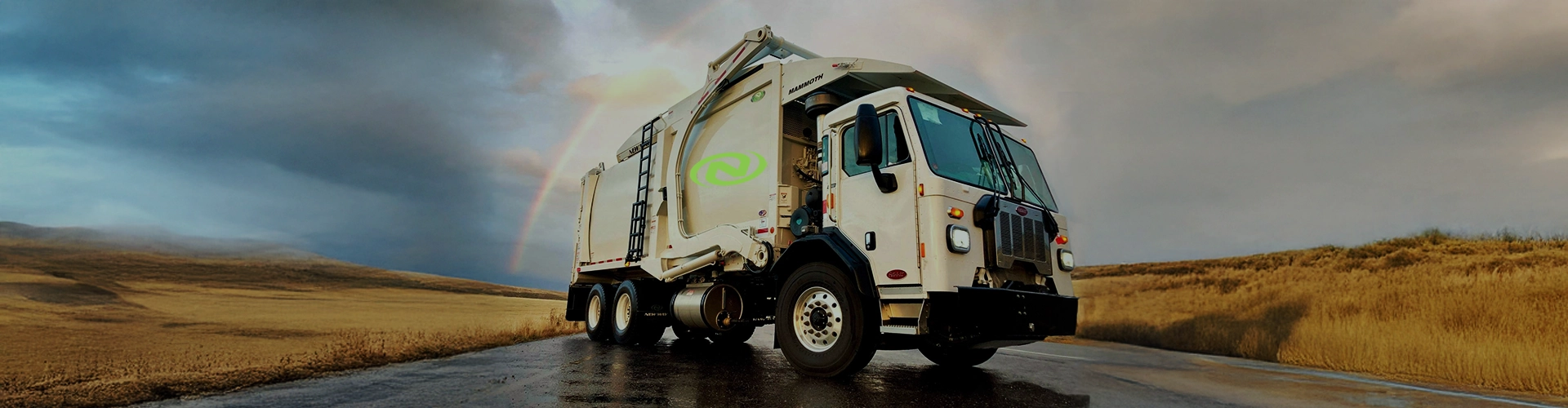 New Way Refuse Truck with Rainbow in background